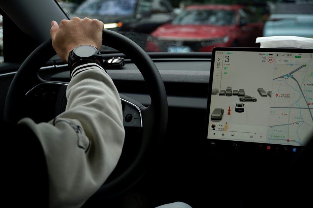 Driving a car with a large digital display.