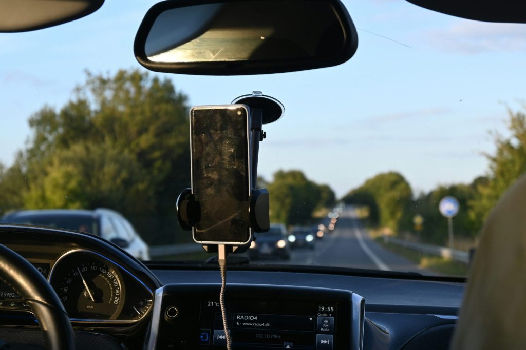 a car dashboard with a cell phone attached to it